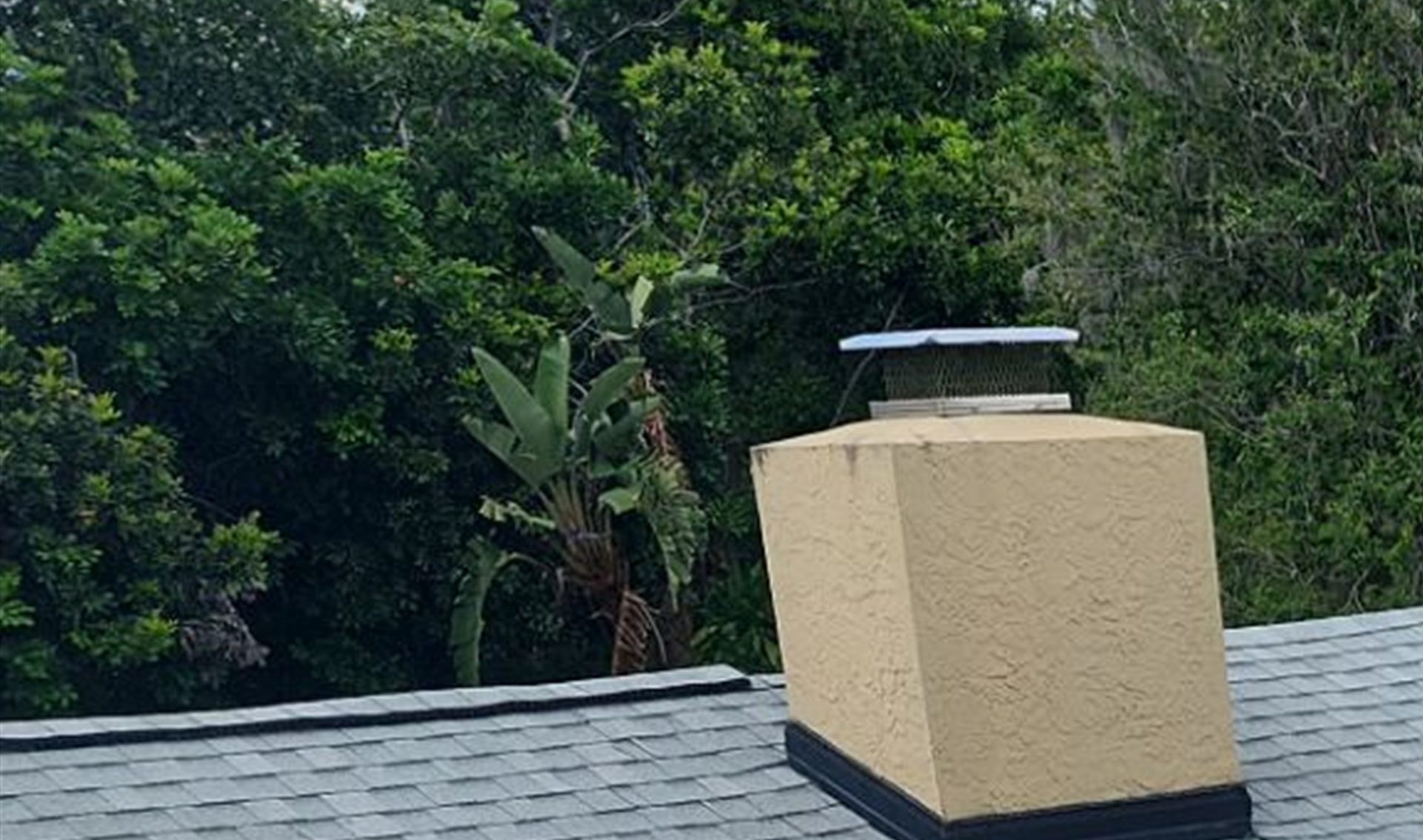 Roofer performing detailed roof maintenance inspection on a Florida home